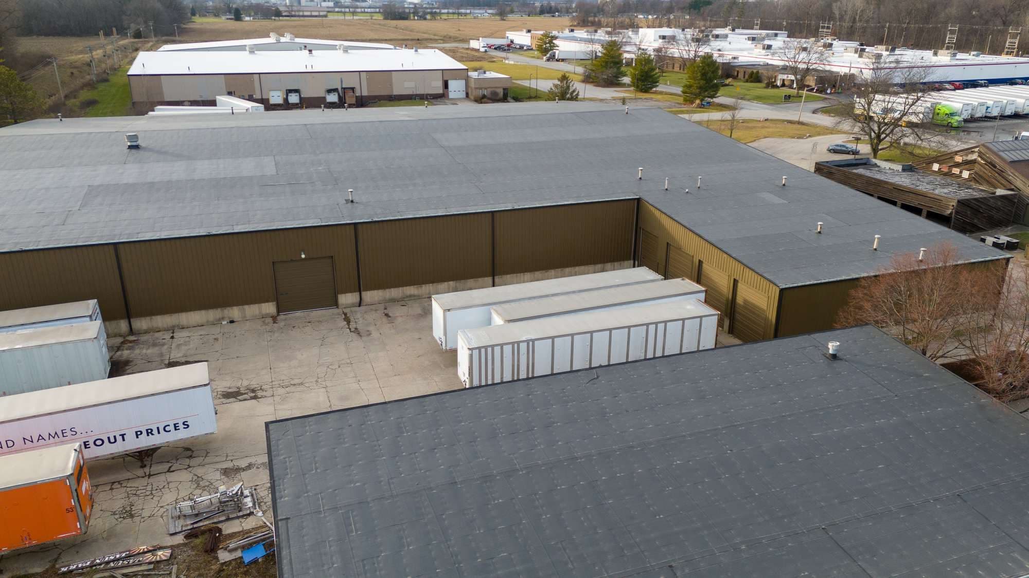 Close aerial of the warehouse loading court and overhead doors