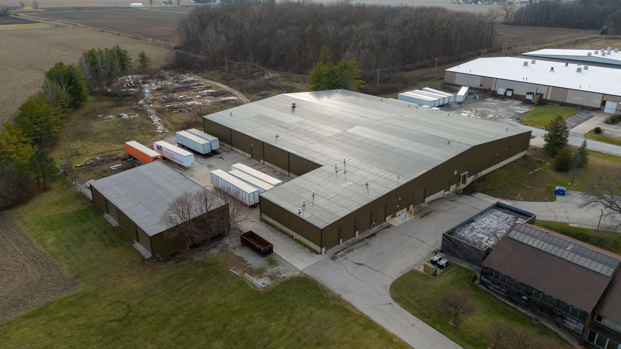 Aerial view of the rear of the Bluffton warehouse with trailer parking and adjacent woodland