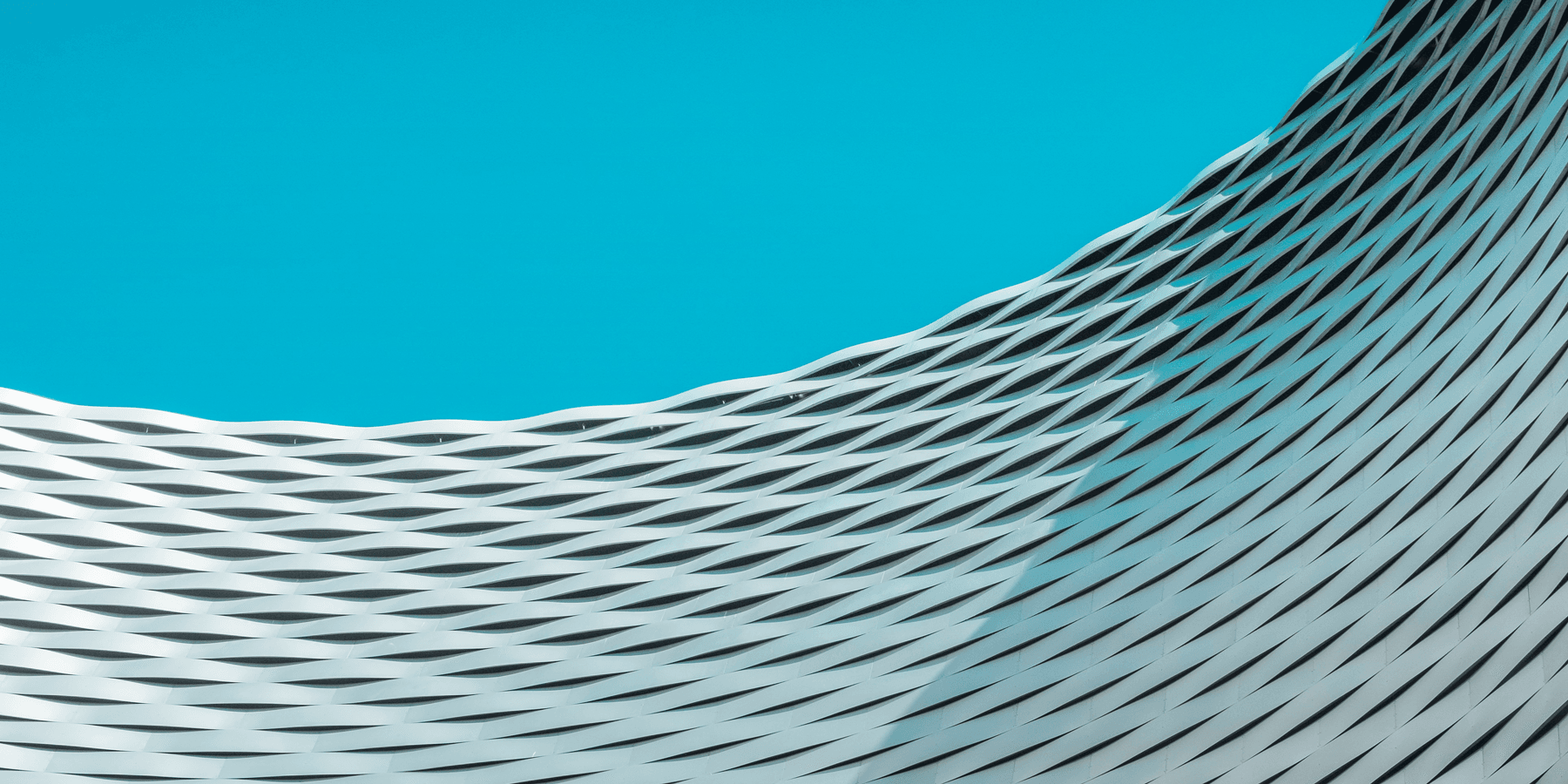 a building with wavy lines on it against a blue sky